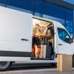 Delivery,Worker,Loading,Boxes,Into,Van